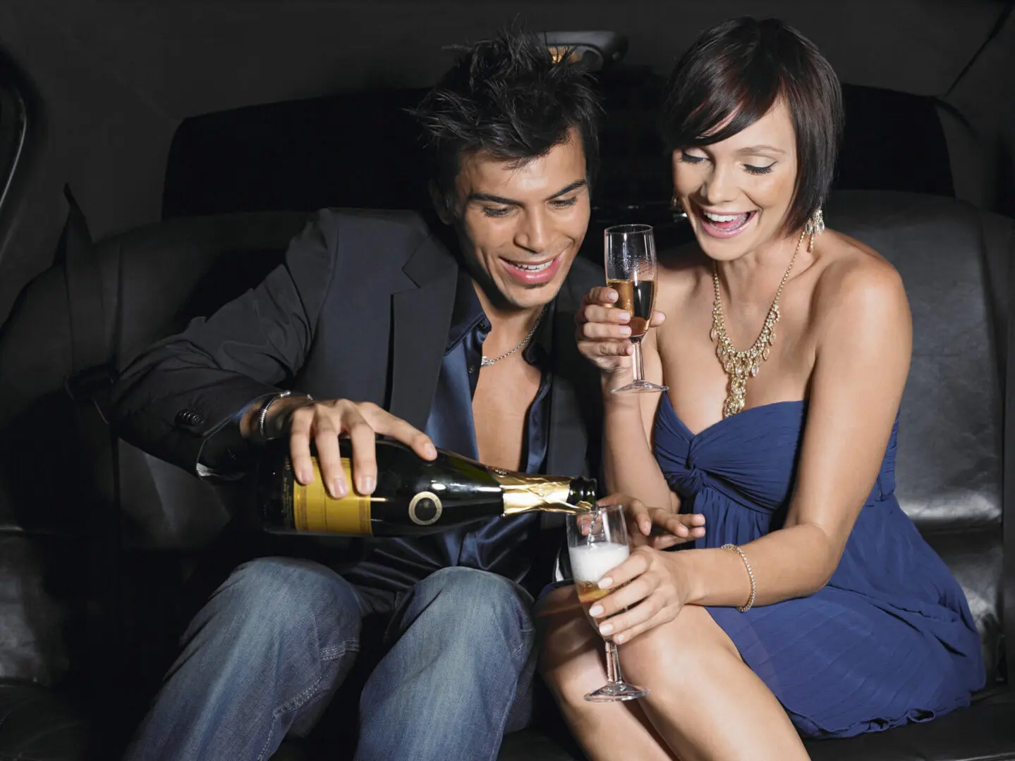 Couple enjoying champagne in a luxury event limousine limo - cascade limo service calgary