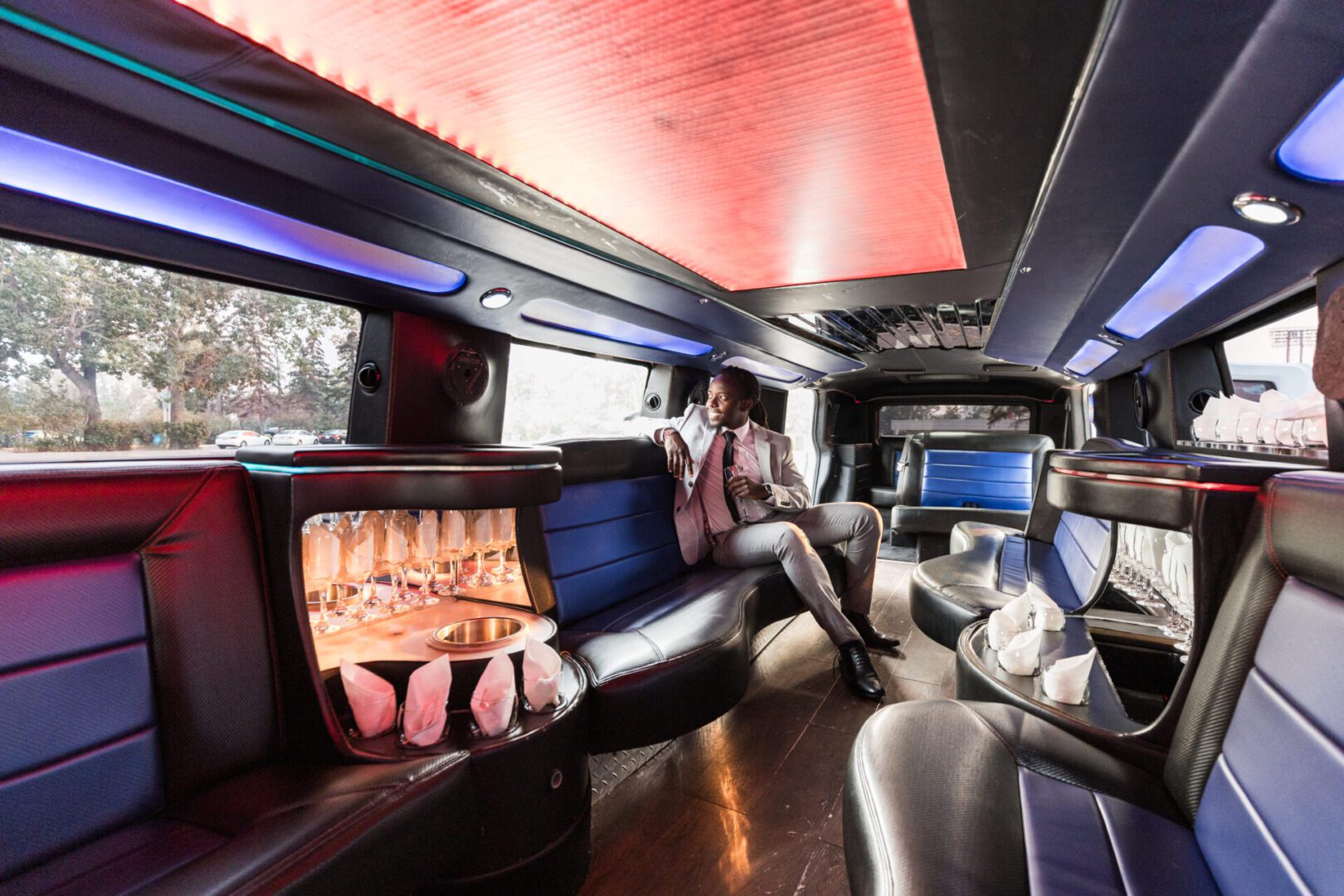 A man sitting in the back of a limo.