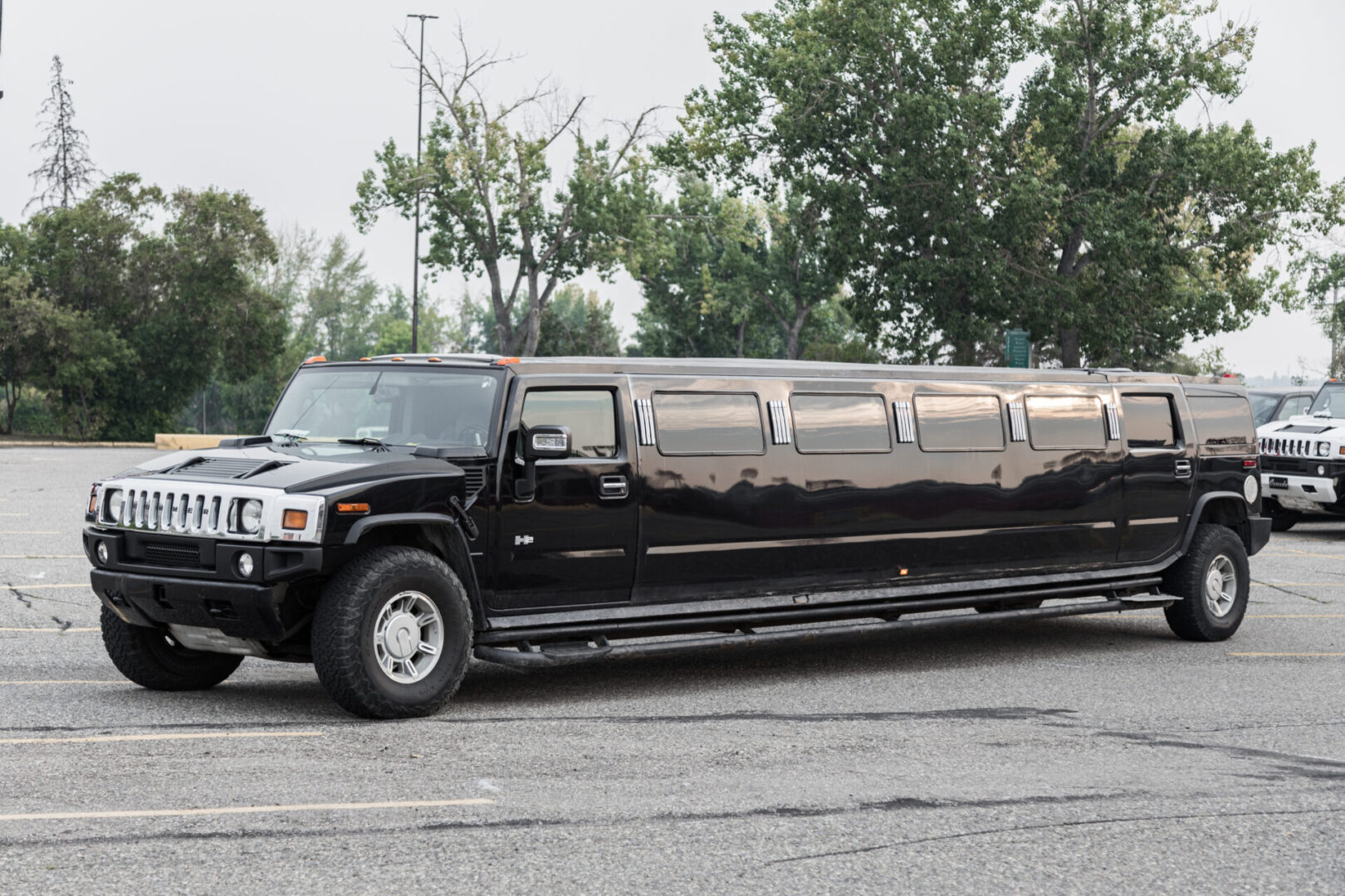 A black limo is parked in the parking lot.