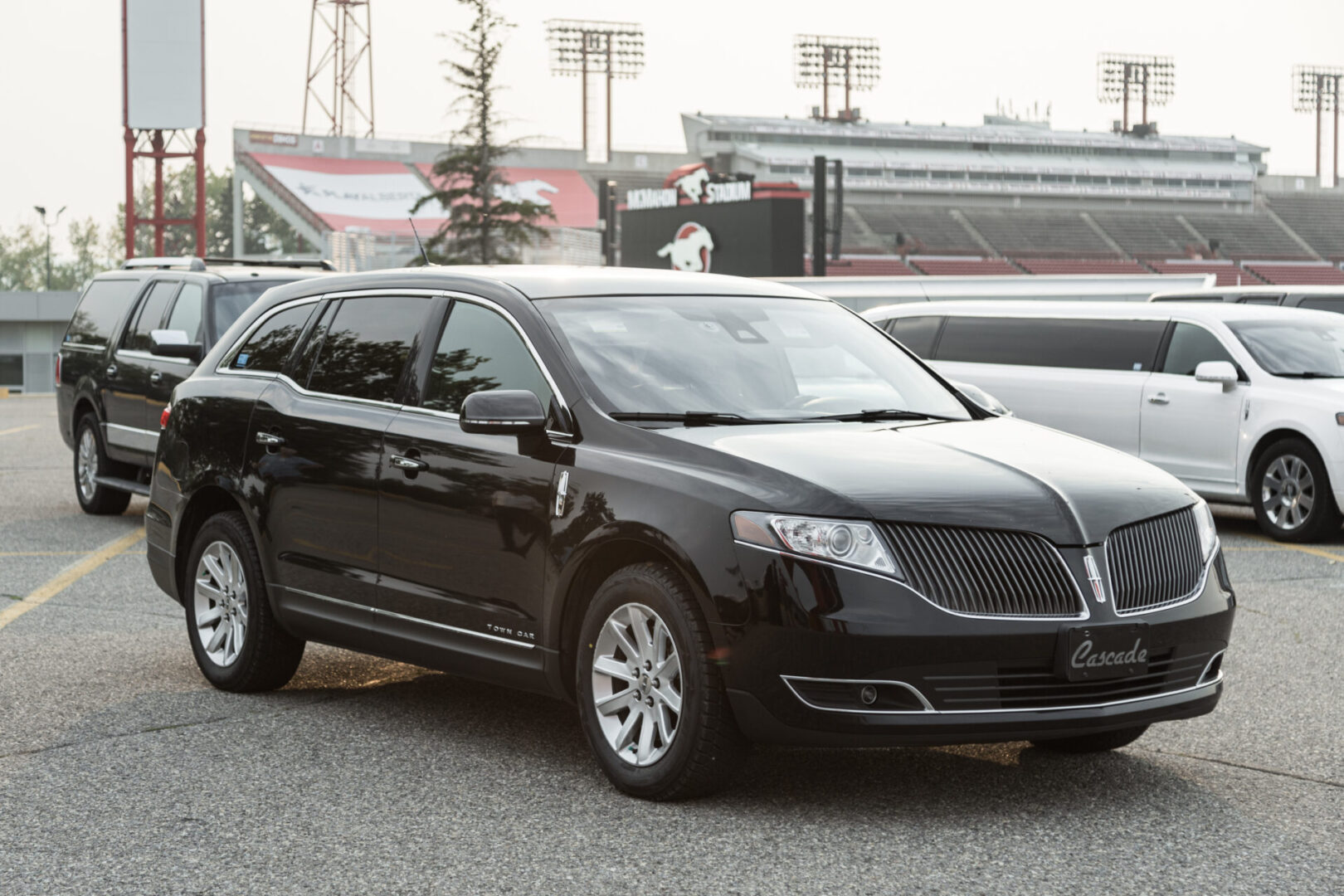 A black lincoln mkt is parked in the parking lot.