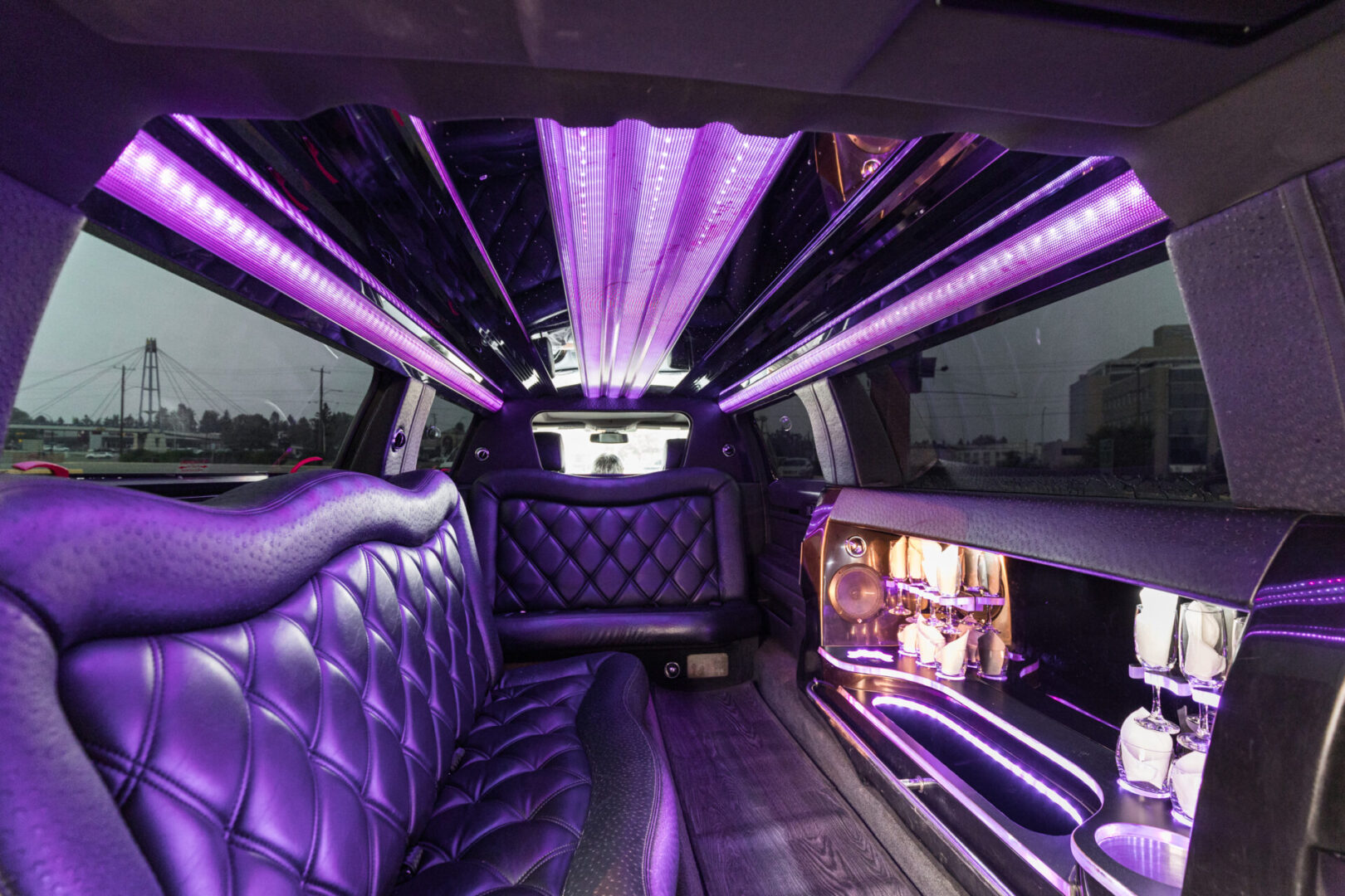A limo with purple lights and leather seats.