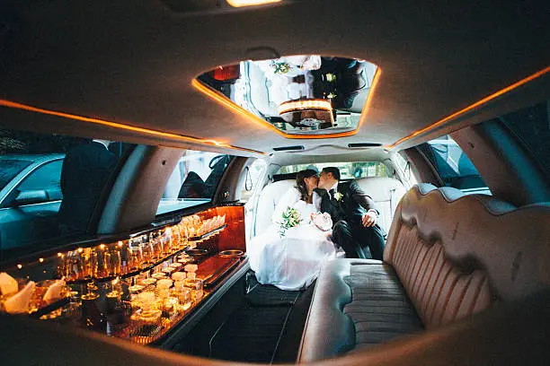 couple kissing in a wedding limousine - cascade limo service calgary